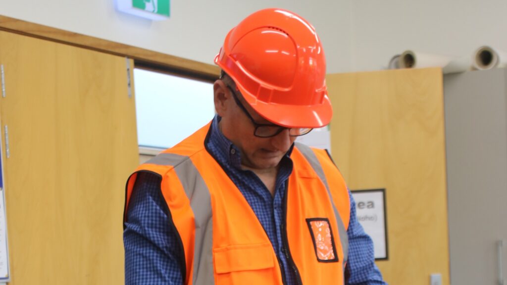 a man wearing a hard hat and vest