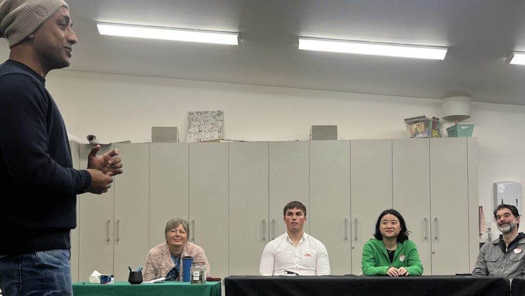 Business owner standing up discussing his history and current business and taking a Q&A during networking