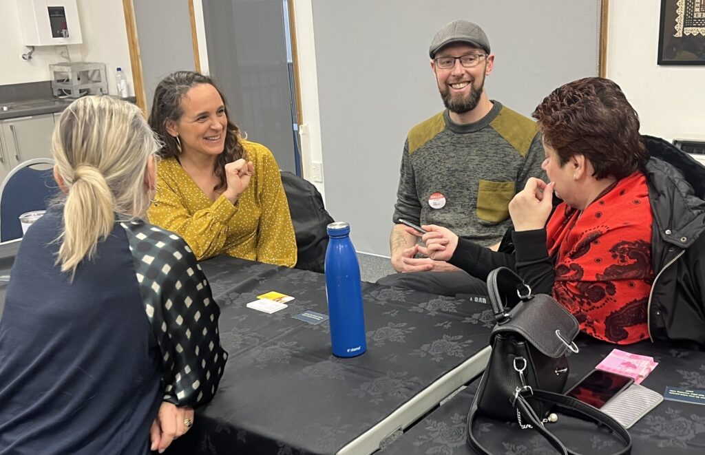 Sharing ideas, four people during the networking session where they share ideas, wins, successes and challenges.