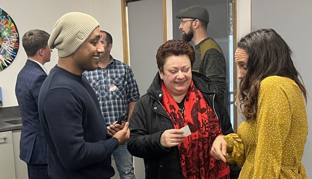 Diverse group of people chatting and building relationships at the end of a Talk Business networking session