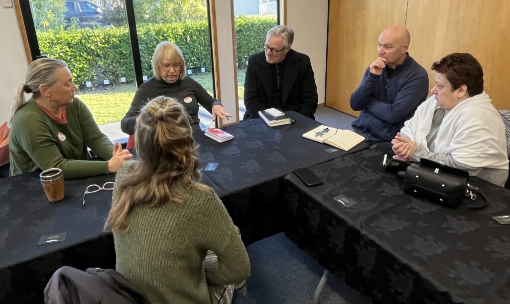 Group of six people in round table discussion at Talk Business