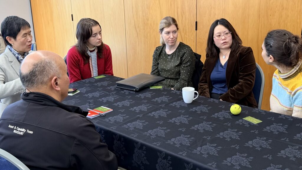 Round table discussion between five women and a man